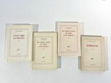 quatre livres posés sur une table blanche, sur fond blanc
