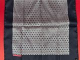 a black and white handkerchief on a red background