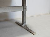 a black seat on a metal bench in the corner of a room