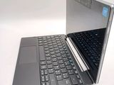 a laptop computer that is open on a white surface