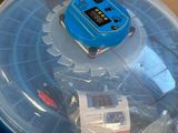 a plastic container with a toy inside of it on top of a cardboard box