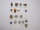 a lot of badges on a piece of paper on the wall