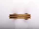 a close up of a gold ring on a white surface