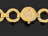 a close up of a number of gold rings on a black surface