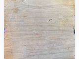 a piece of wood with a drawing on it and writing on it