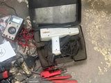 a box with tools and wires on the ground