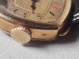 a close up of a watch on a white surface