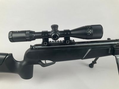 a rifle with a scope and a scope scope on a white background