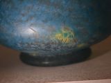 a blue vase sitting on top of a table