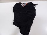 a black swimsuit with a large bow on the front