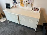 a picture of a white cabinet with pictures on it