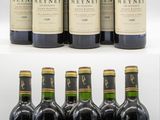 several bottles of wine are lined up on a white surface