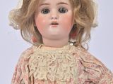 a doll that is wearing a dress and a hat