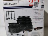 a box with a set of black pots and pans in it