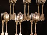 beaucoup de cuillères et de fourchettes en argent sur une table