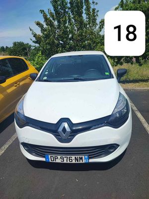 a white car parked in a parking lot next to a yellow car