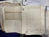 an old book with writing on it sitting on a table