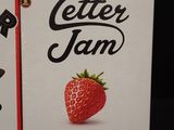 two boxes of letters and a strawberry sitting on a table