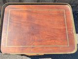 a small wooden table with a tray on top of it