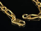 a close up of a gold chain on a black background