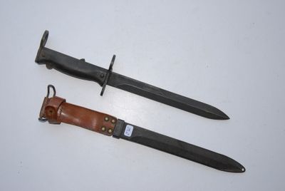 two knives are laying side by side on a white surface