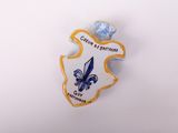 a close up of a badge on a white surface