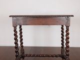an old wooden table sitting on top of a hard wood floor
