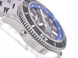 a close up of a wrist watch with a blue bezel