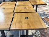 a lot of wooden tables that are sitting on the floor