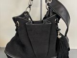 the black purse is sitting on top of a black table