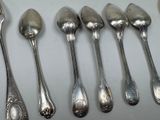 six spoons that are lined up on a table