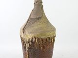 a brown and brown vase with a man ' s head on it