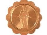 a gold medal with a picture of a woman on it