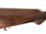 a close up of a rifle on a white surface