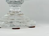 a clear glass bowl with a brown base on a white surface