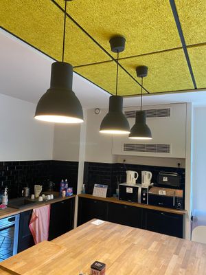 a kitchen with a wooden table and black cabinets