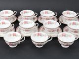 a group of six cups and saucers with pink flowers