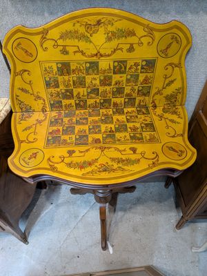 a yellow table with a chess board on top of it