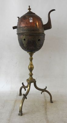 an antique brass tea kettle on a stand with a teapot on top