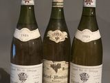 three bottles of wine sitting on top of a table next to each other