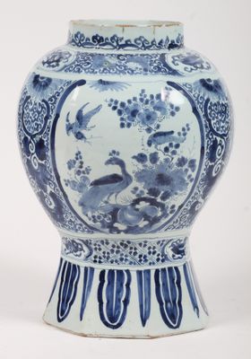 a blue and white vase with a bird design on it