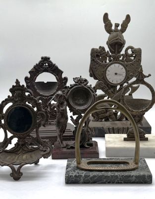 a lot of antique clocks that are sitting on a table