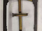 a metal frame with a cross on it on a white surface