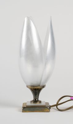 a pair of scissors that are next to a lamp