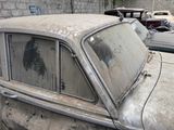 a old car that is sitting in a parking lot