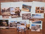 a lot of postcards on the wall of a room