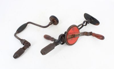 pair of antique hand cranks on a white background