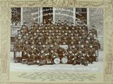 an old photo of a group of men in uniform posing for a picture