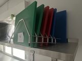several pieces of plastic are stacked on a shelf in a kitchen