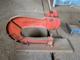 a red machine that is sitting on the ground